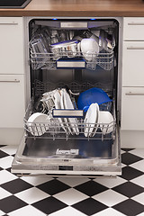 Image showing Dishwasher loades in a kitchen with clean dishes