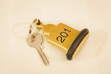 Image showing Hotel Room Key lying on Bed with keyring