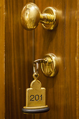 Image showing Hotel Room Key lying on Bed with keyring