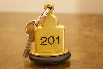 Image showing Hotel Room Key lying on Bed with keyring