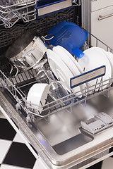 Image showing Dishwasher loades in a kitchen with clean dishes