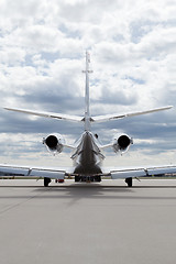 Image showing Aircraft learjet Plane in front of the Airport with cloudy sky