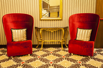 Image showing Royal Armchair in red in warm athmosphere decoration