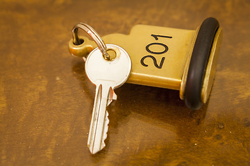 Image showing Hotel Room Key lying on Bed with keyring