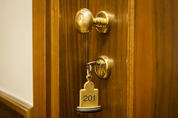 Image showing Hotel Room Key lying on Bed with keyring