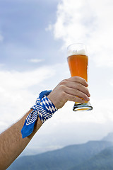 Image showing Bavarain man holding wheat beer glass in the air