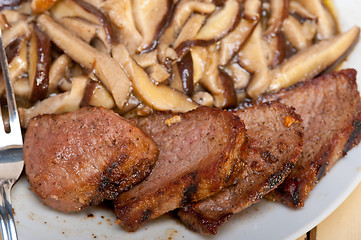 Image showing venison deer game filet and wild mushrooms