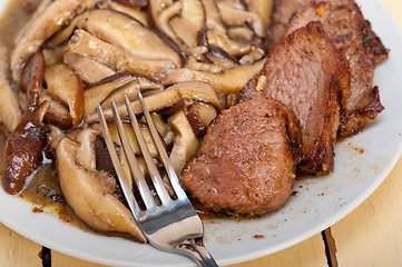 Image showing venison deer game filet and wild mushrooms