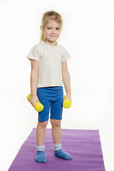 Image showing Four-year girl standing with dumbbells