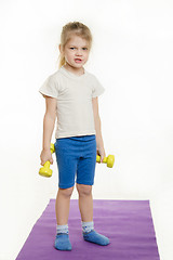 Image showing Funny four-year girl with dumbbells