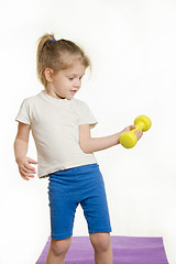 Image showing Four-year girl is engaged in raising the dumbbell exercise