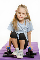 Image showing Six year old girl hanging on the palm pushups