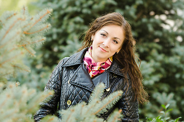 Image showing Portrait a twenty-five girls on the background of fir trees