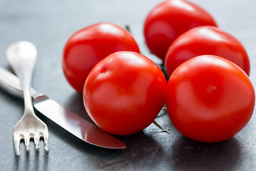 Image showing Ripe tomatoes, knife and fork.