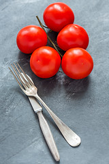 Image showing Ripe tomatoes and cutlery.