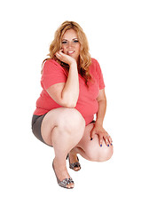 Image showing A crouching plus size woman.