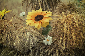 Image showing Decoration of artificial flowers and ears of corn.