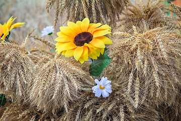 Image showing Decoration of artificial flowers and ears of corn.