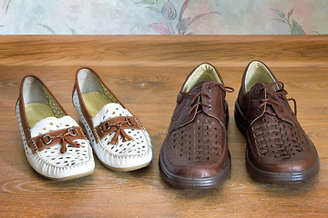 Image showing Two pairs of comfortable shoes : for men and for women.
