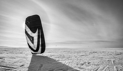 Image showing Kiteboarder with blue kite on the snow