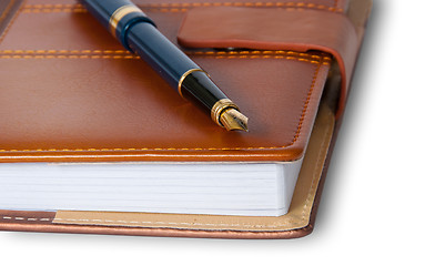 Image showing Closeup fountain pen on top of the closed notebook