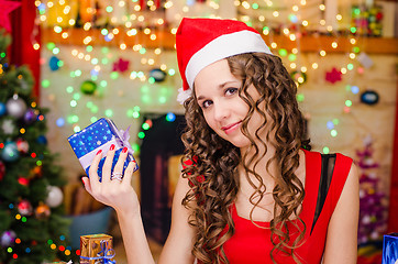 Image showing Beautiful girl holding a Christmas gift