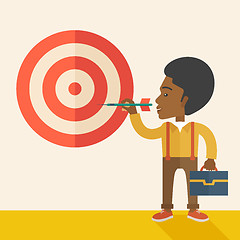 Image showing Working black man holding a target arrow 