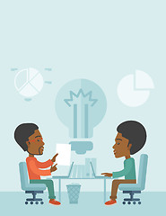 Image showing Two african businessmen sitting working together.