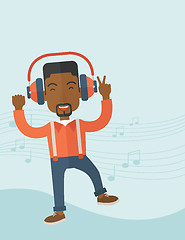 Image showing Happy young man dancing while listening to music.