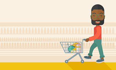 Image showing Black Male Shopper Pushing a Shopping Cart.