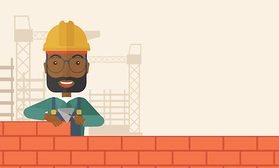 Image showing Black builder man is building a brick wall.