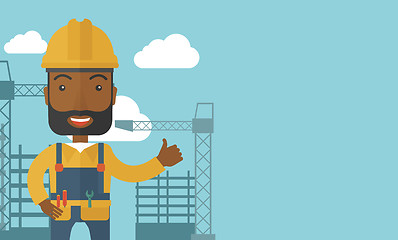 Image showing Black man standing infront of construction crane tower.