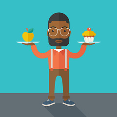 Image showing Man carries with his two hands cupcake and apple.