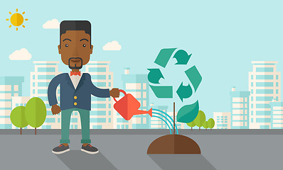 Image showing Man watering a recycling tree.