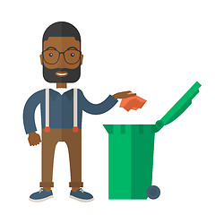 Image showing Black man throwing paper in a garbage bin.