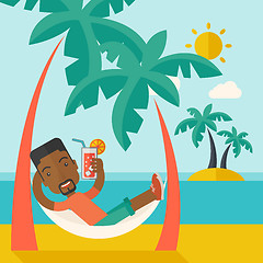 Image showing Young black man on th beach relaxing and drinking cocktail.