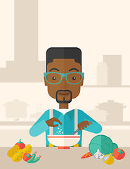 Image showing Young black guy is eating salad for lunch in the restaurant.