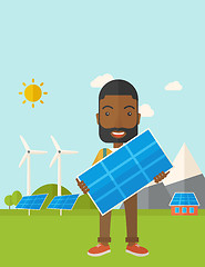 Image showing African man holding a solar panel.