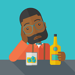 Image showing Sad african man alone in the bar drinking beer.