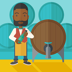 Image showing African Wine maker inspecting wine from barrel.