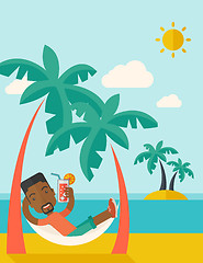 Image showing Young black man on th beach relaxing and drinking cocktail.