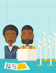 Image showing Two black Workers using laptop with windmills.