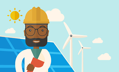 Image showing Black man in solar panel and windmills.