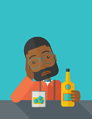 Image showing Sad african man alone in the bar drinking beer.