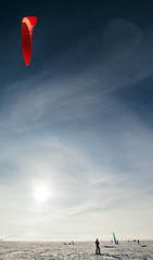 Image showing Kiteboarder with blue kite on the snow