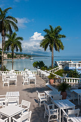 Image showing White tables and chairs  in tropical garden  on a beautiful  beach