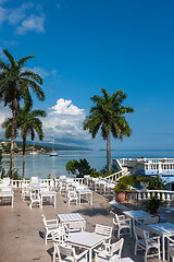 Image showing White tables and chairs  in tropical garden  on a beautiful  beach