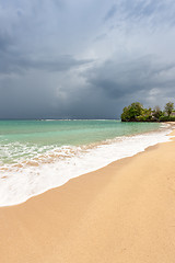 Image showing Beach on tropical island. Clear blue water, sand, clouds. 