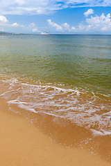 Image showing Beach on tropical island. Clear blue water, sand, clouds. 