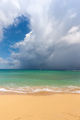 Image showing Beach on tropical island. Clear blue water, sand, clouds. 